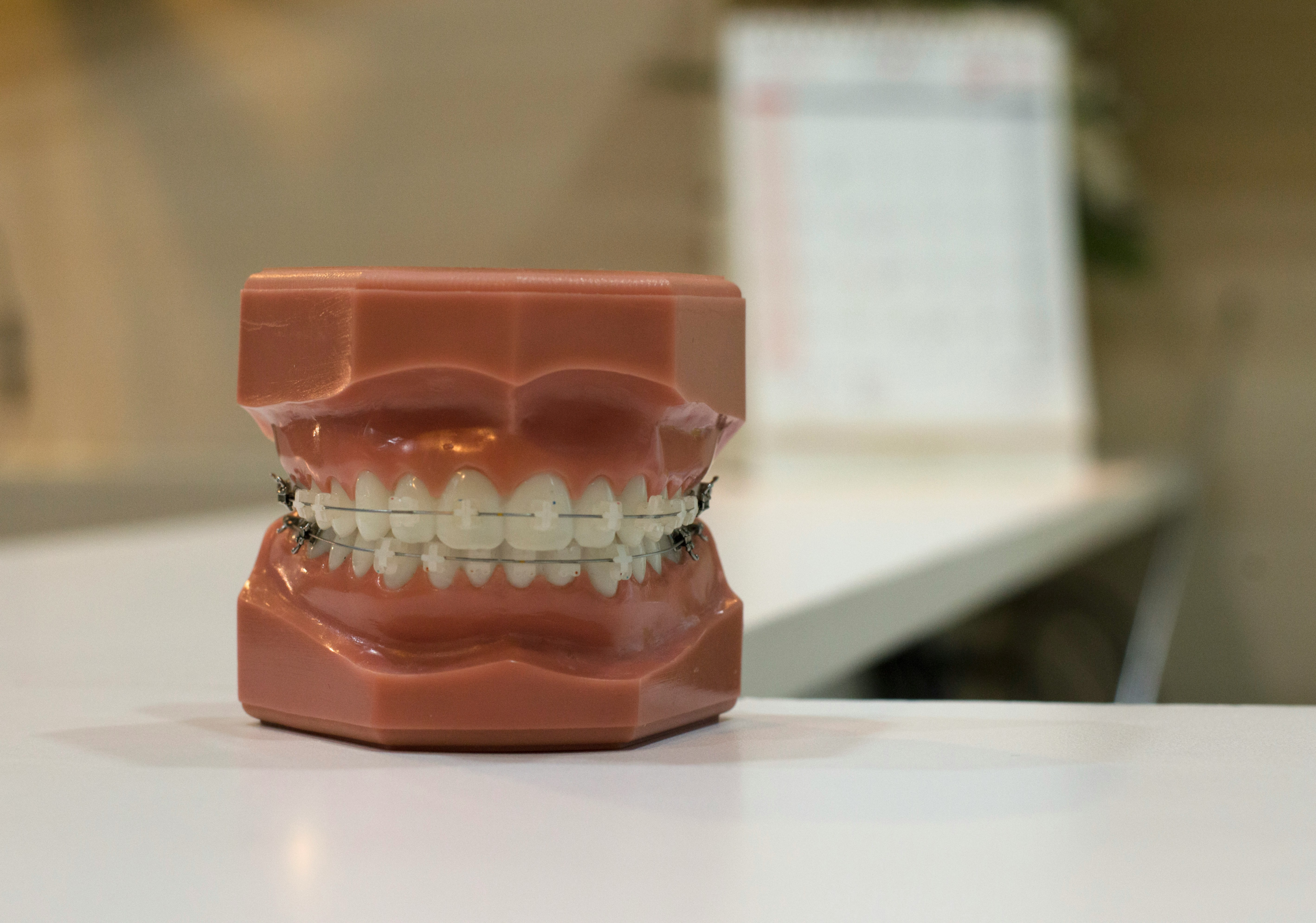 a dental model with braces on the teeth showing clear braces