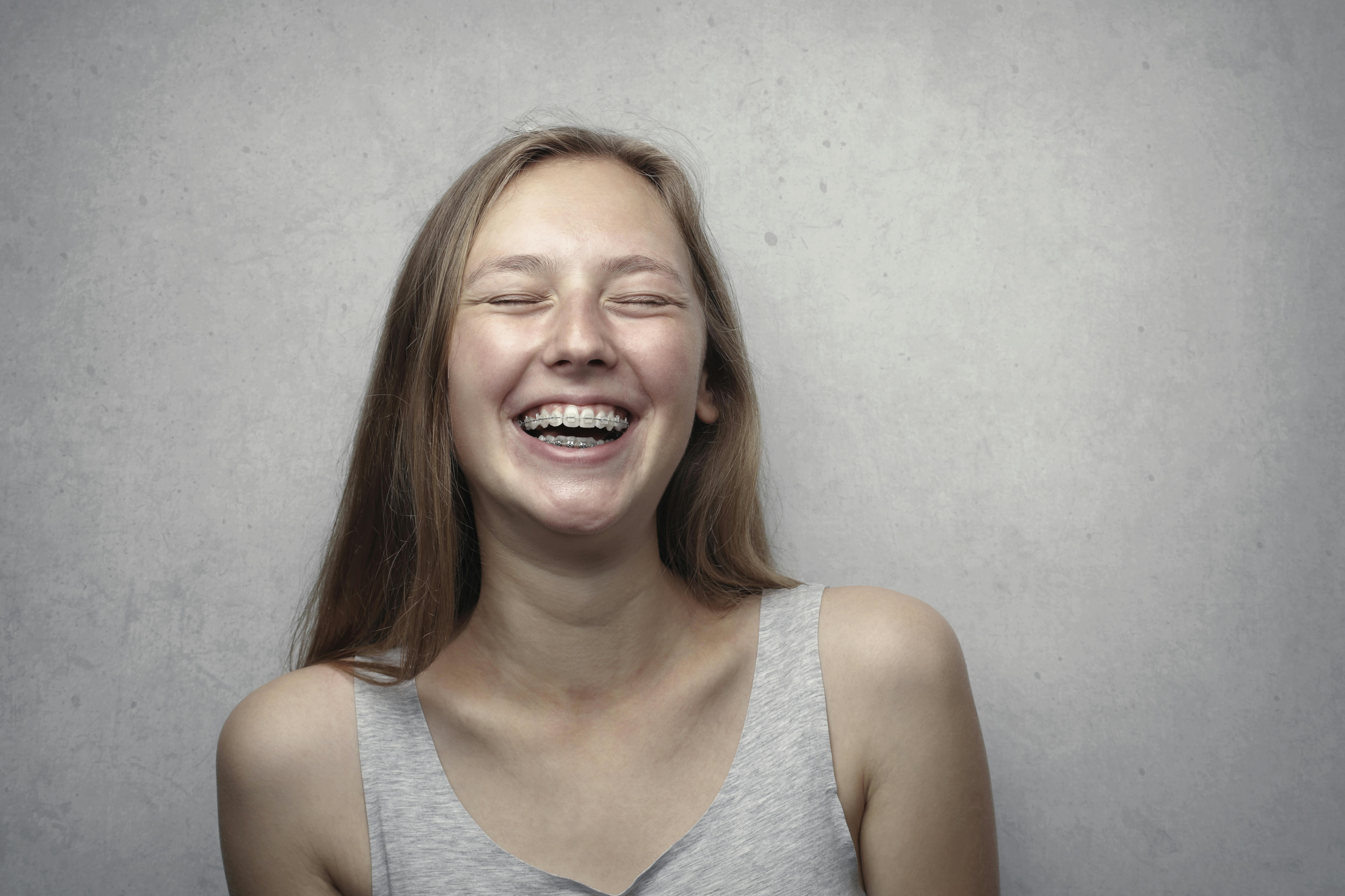 young woman with braces on her teeth to put them in the correct position