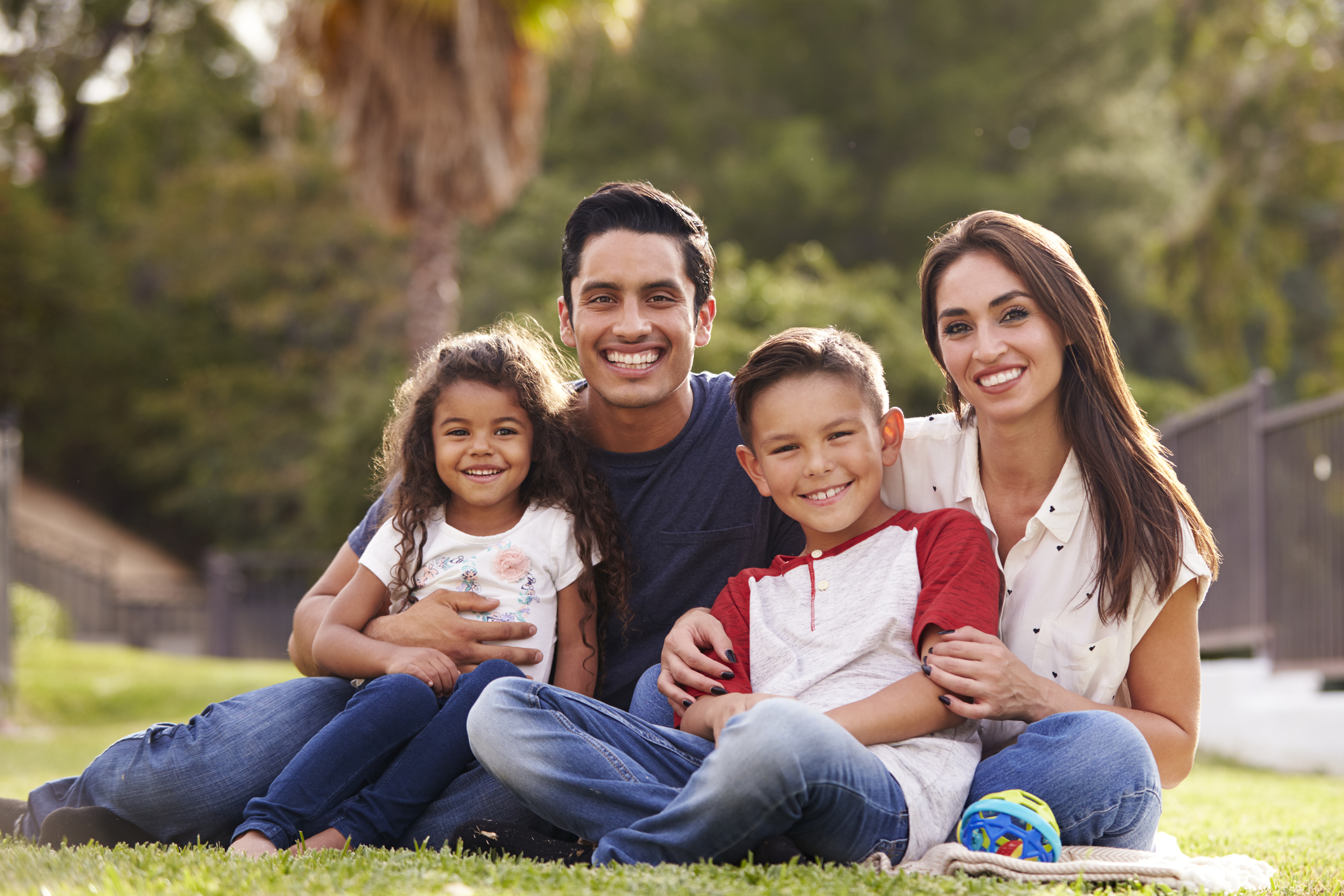 A smiling family that wants invisalign aligners instead of traditional braces