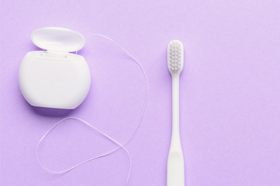 soft bristled toothbrush and floss used to maintain healthy oral status 