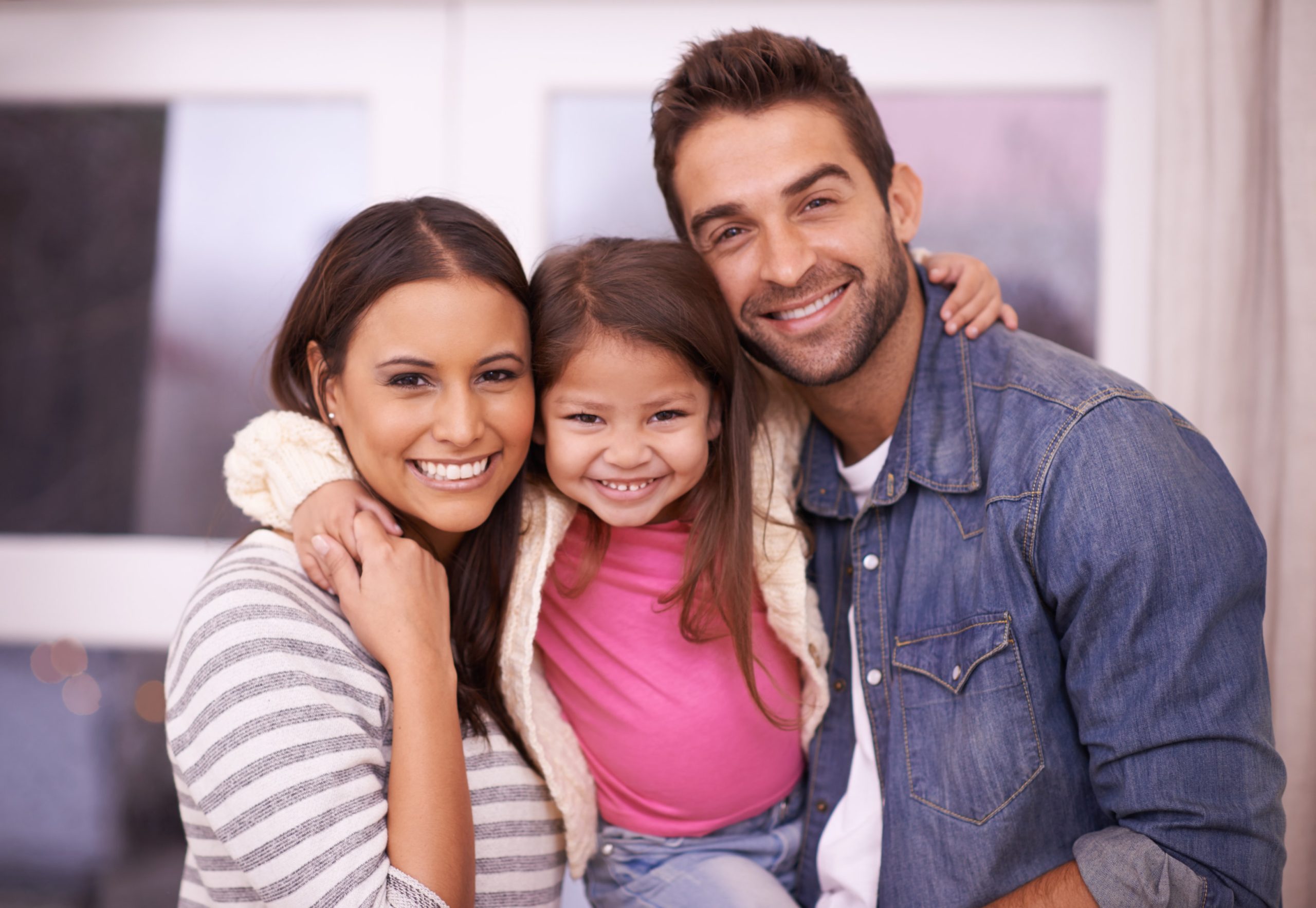 Family smiling with straight teeth