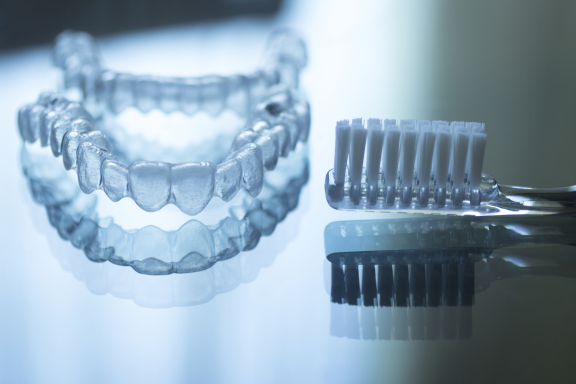 a removable retainer beside a toothbrush 