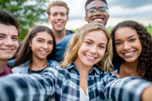 group of teens take a selfie after overbite treatment