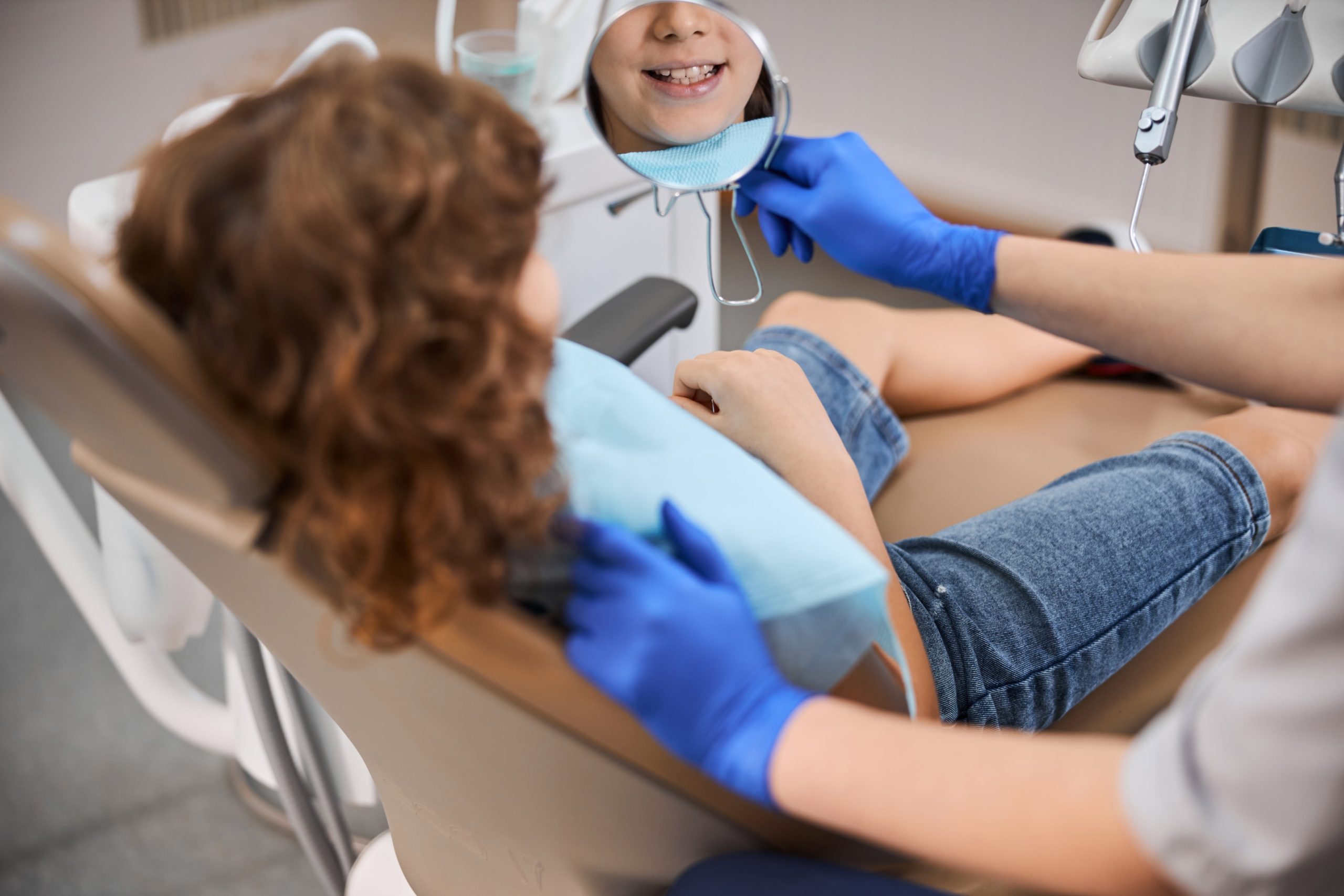 Kid in patient chair seeking treatment for their overbite or underbite 