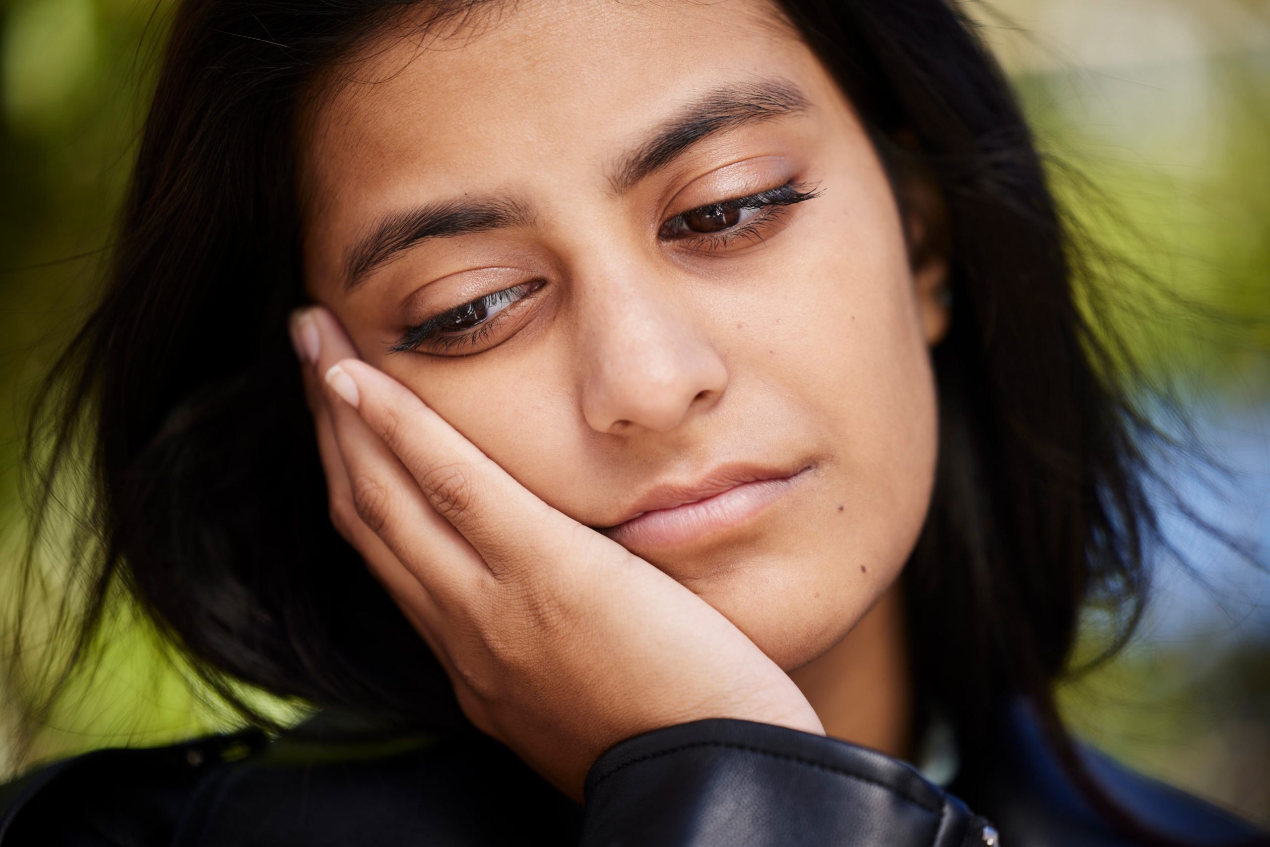 Woman with jaw pain and tired from jaw misalignment impacting her life