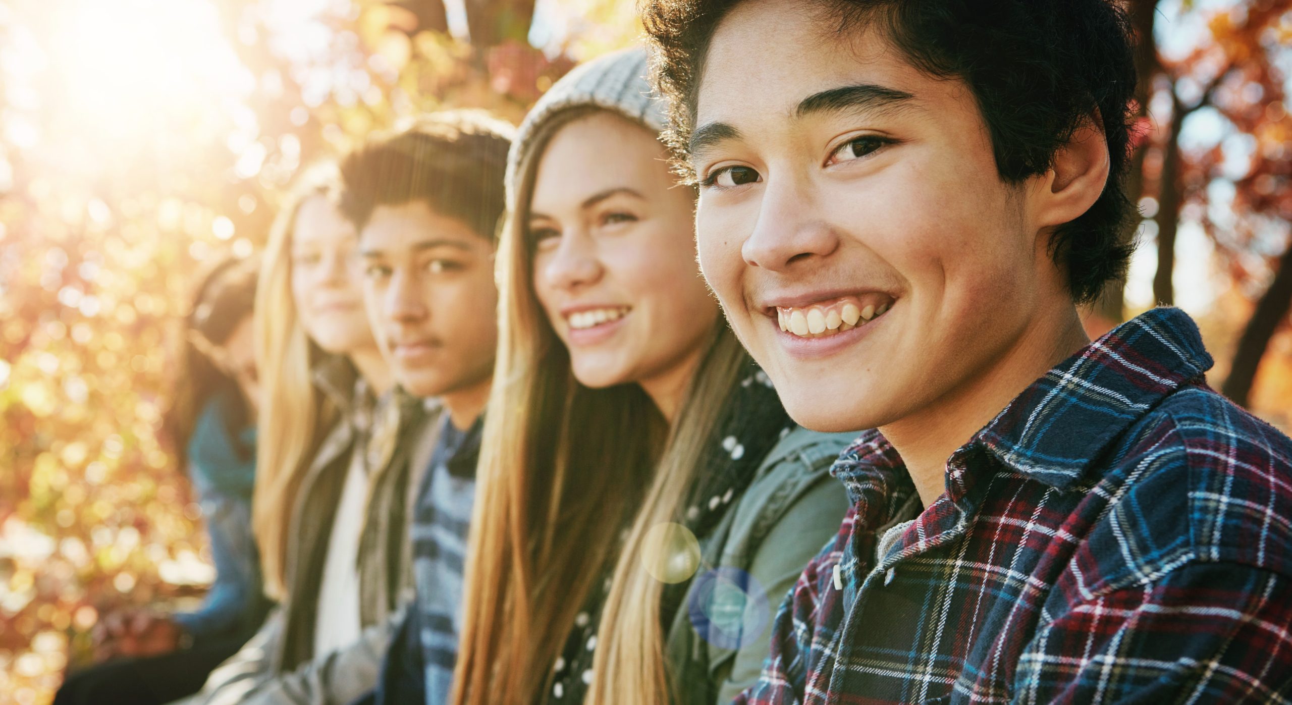 teenagers with their adult teeth smiling about meeting this Calgary orthodontist