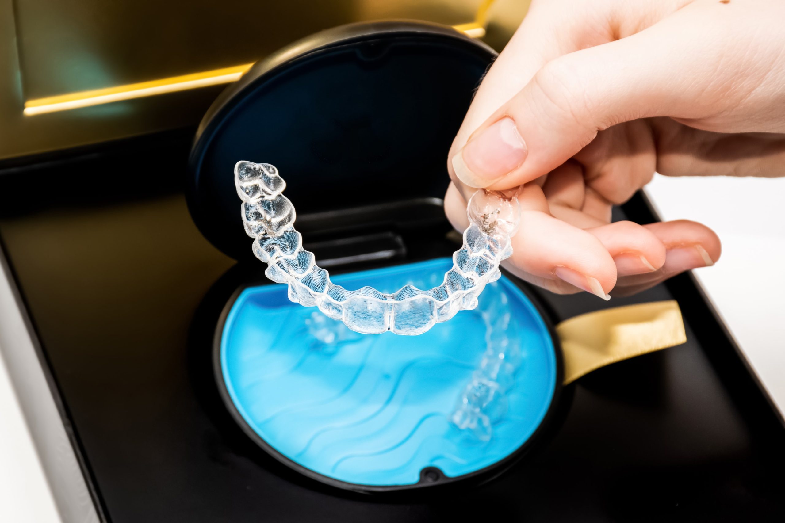 Person placing Invisalign in case