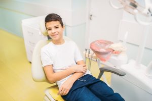 Kid sitting in patient chair for a tooth alignment consultation