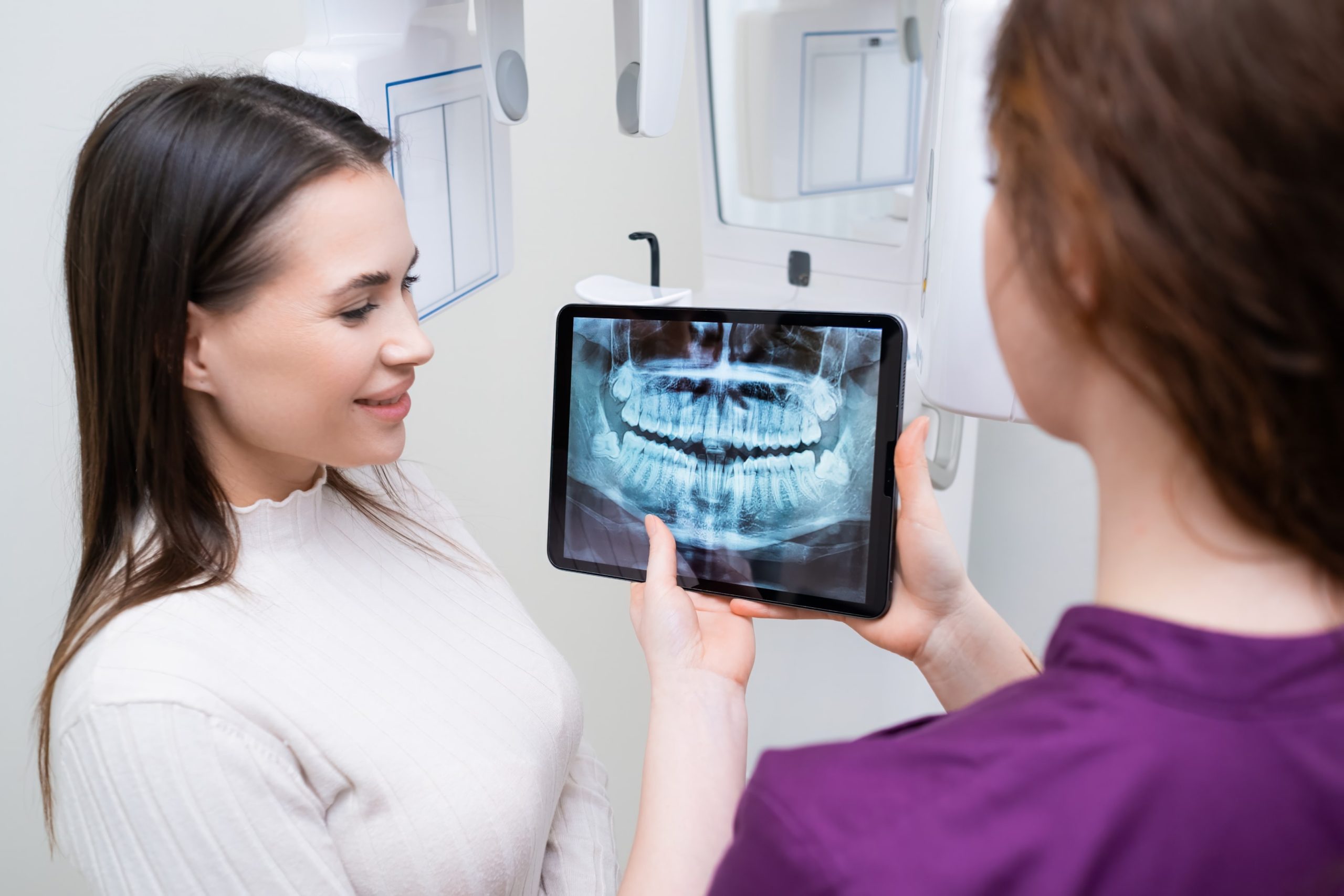 Orthodontist showing a patient her x-ray at her appointment today