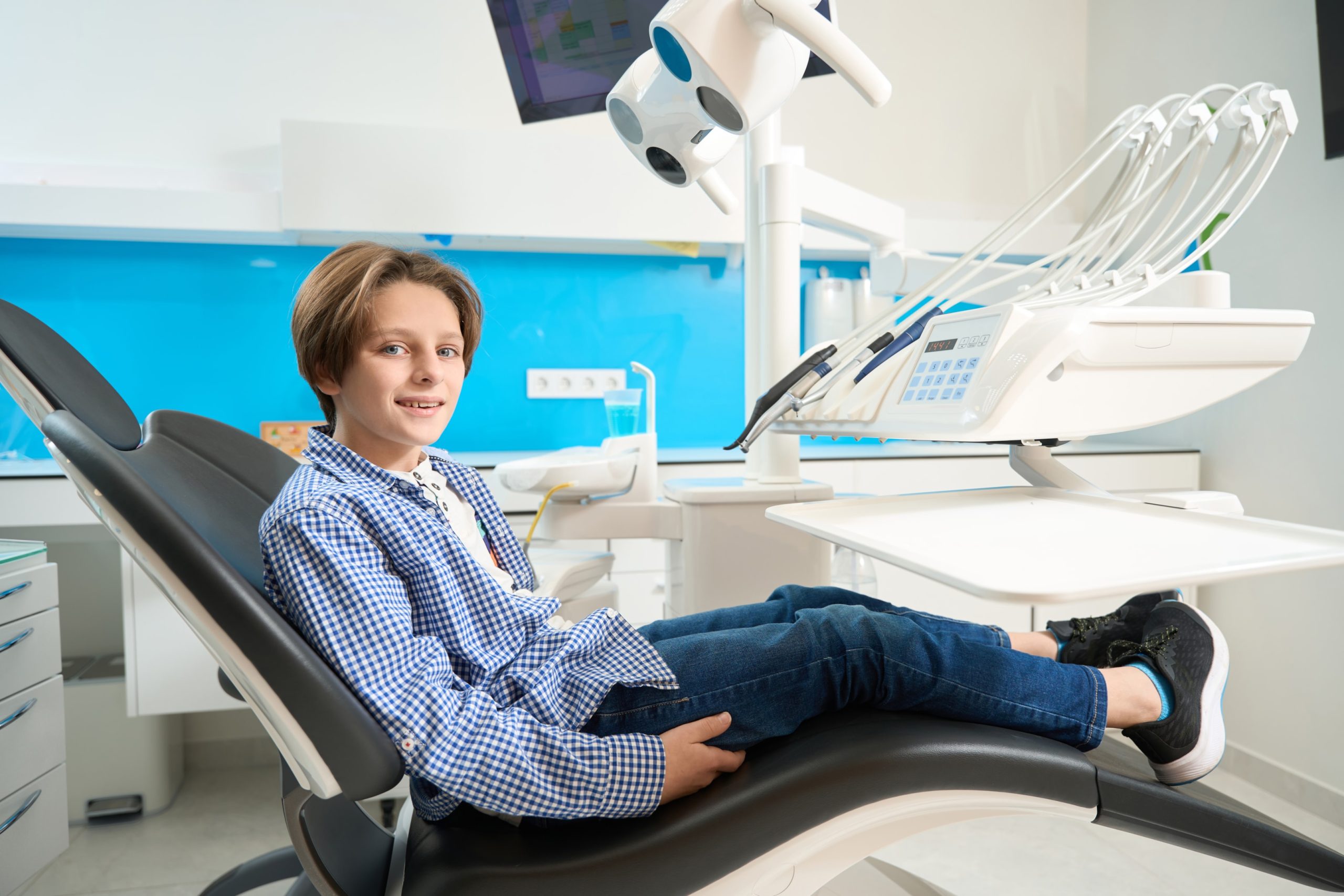 Boy in patient chair getting metal braces