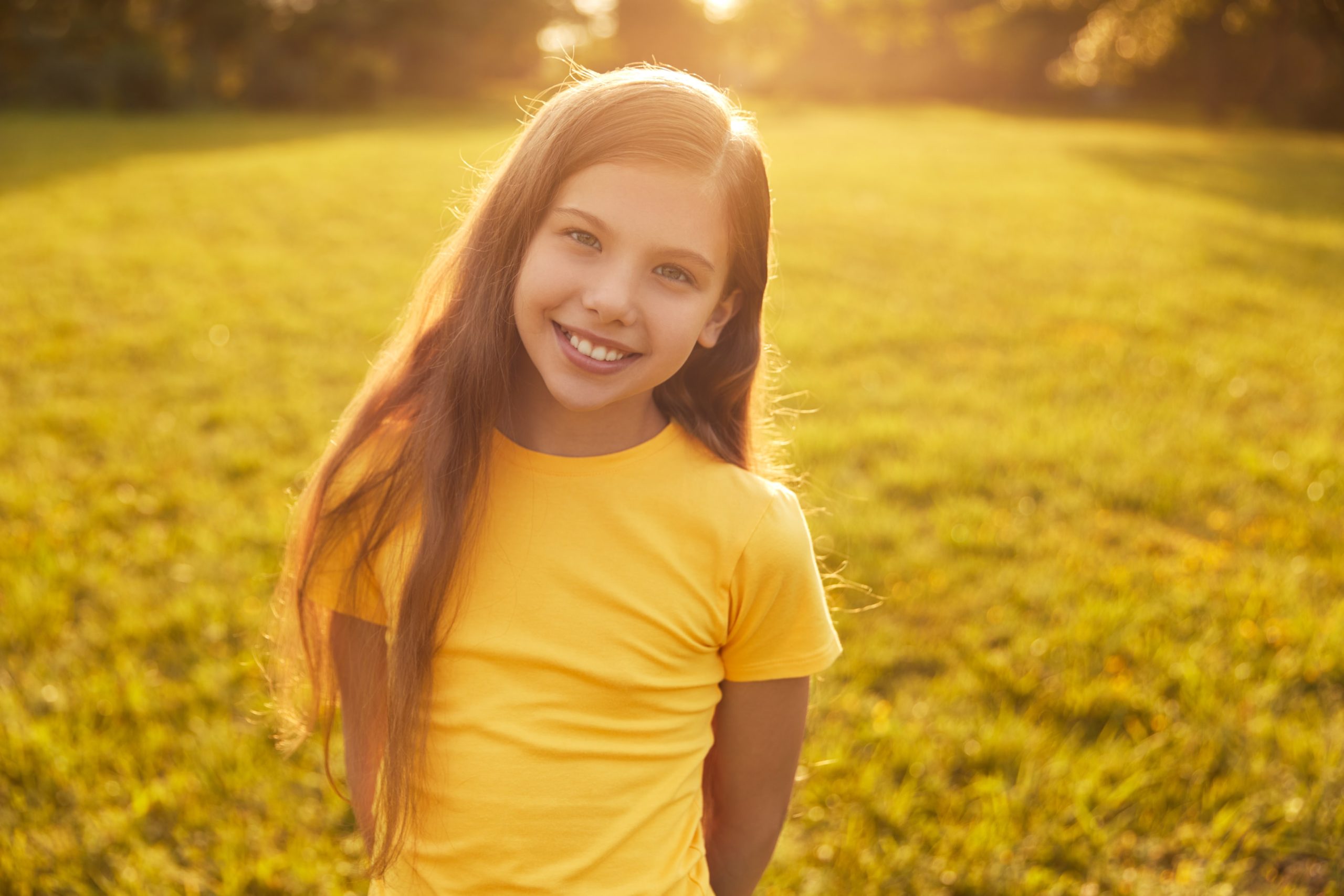 A young girl smiling because she got a free consultation about her straighter smile