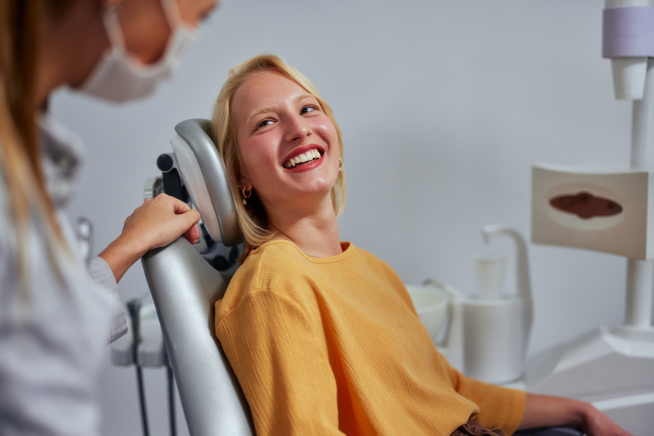 woman in orthodontic chair as a patient to fix crooked teeth 