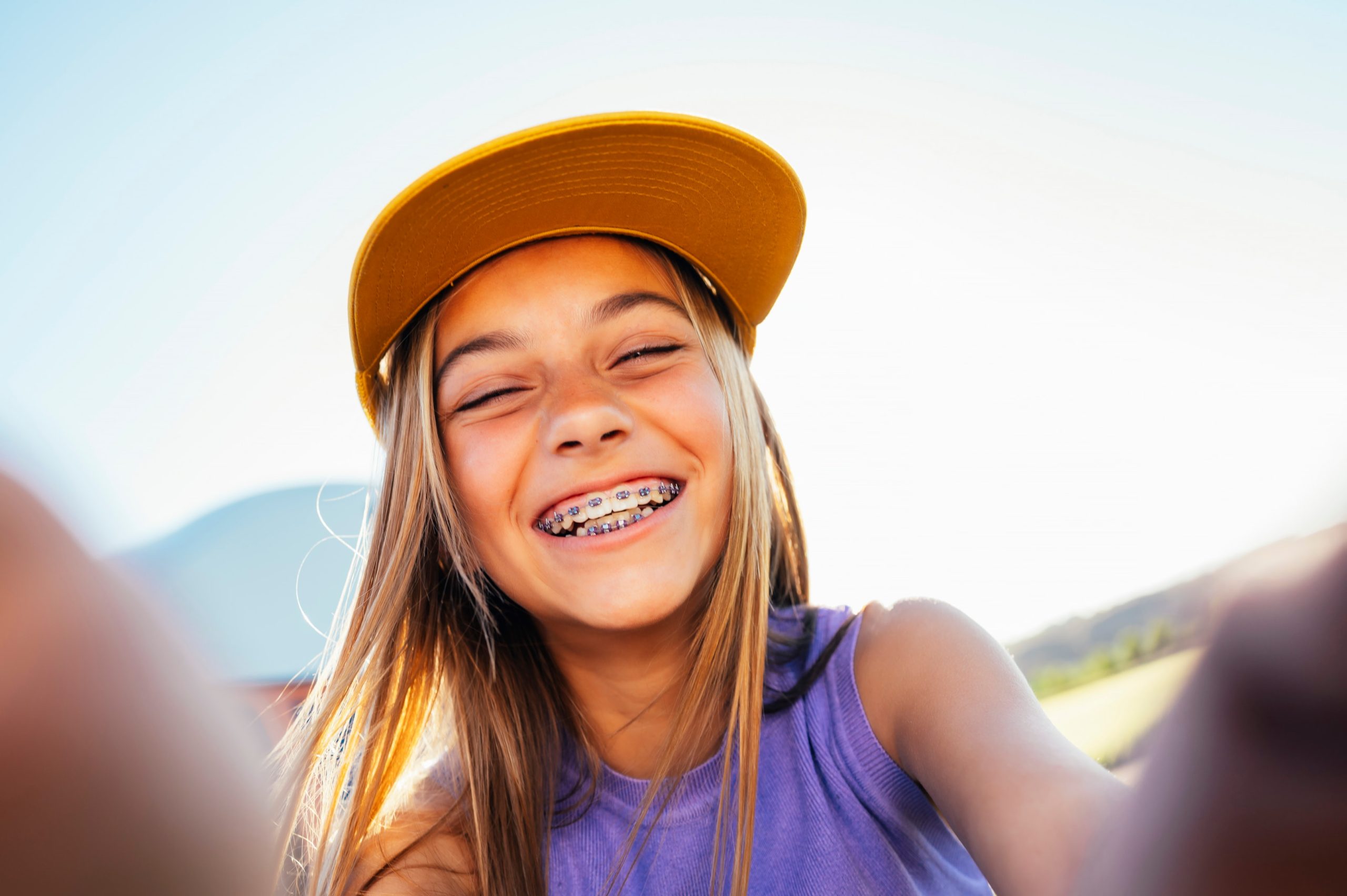 Teenage girl smiling with traditional braces