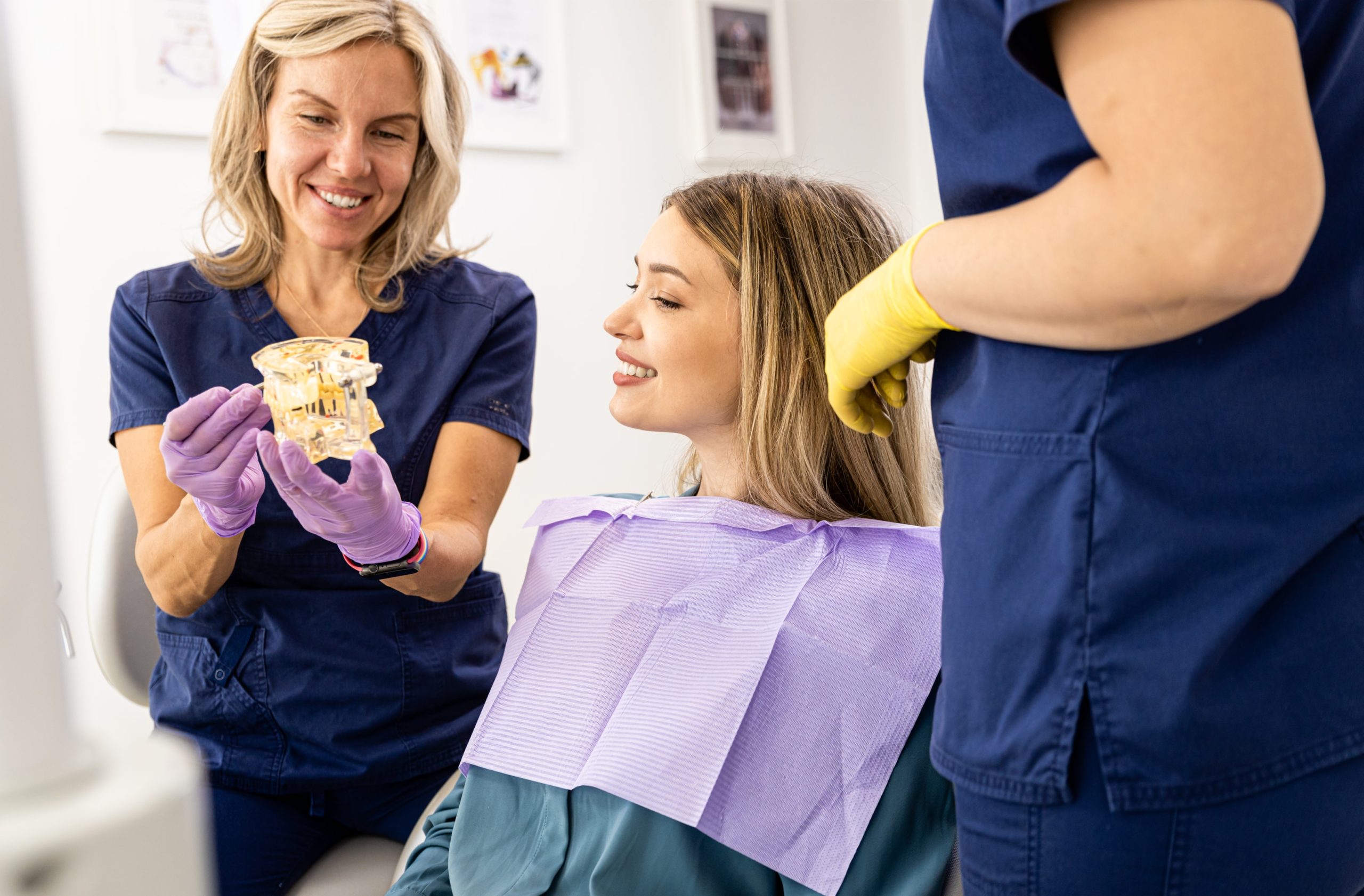 A female orthodontist speaking to a patient about how she can create smiles