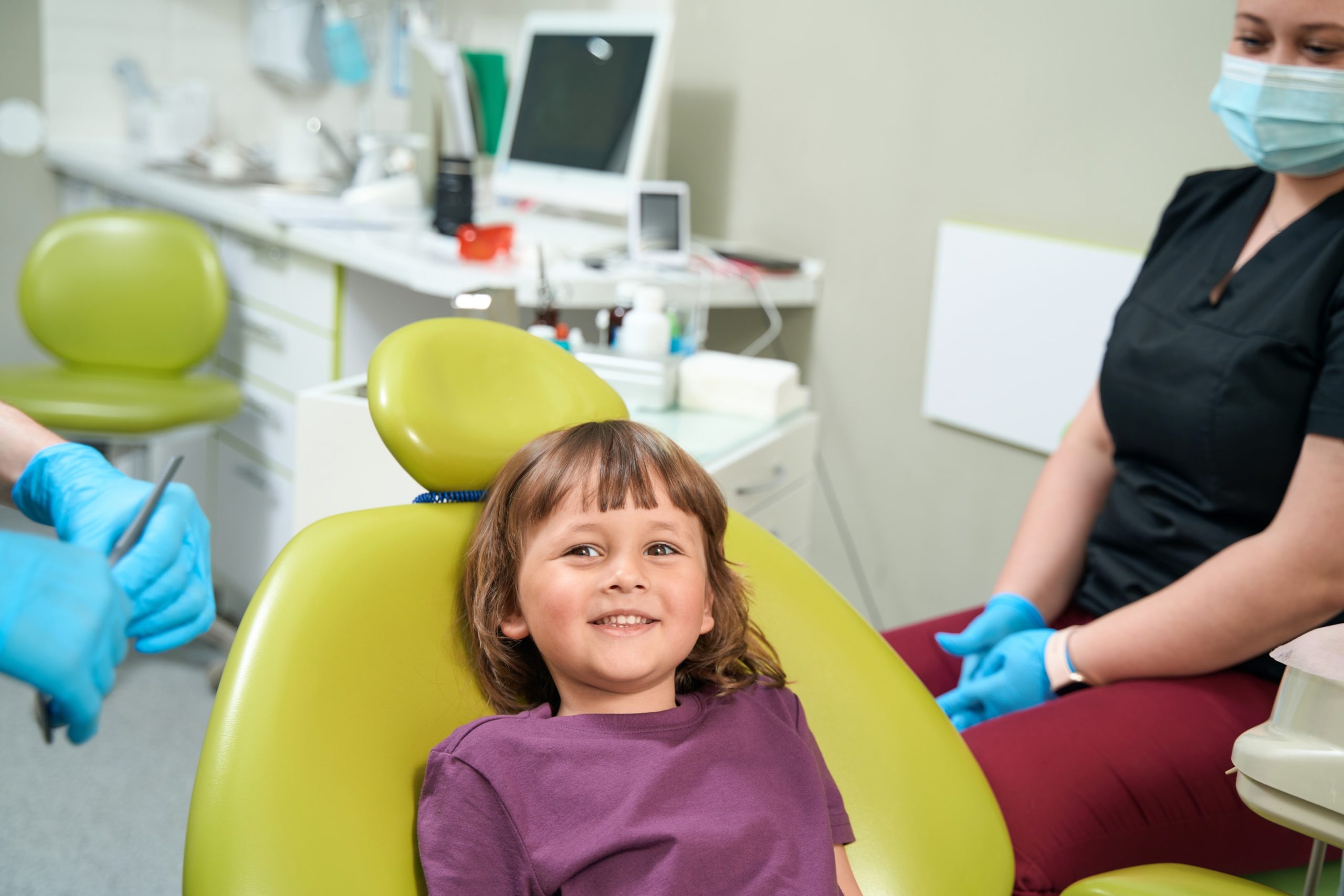 young girl getting assessed early by a kid orthodontic dentist for early intervention treatment