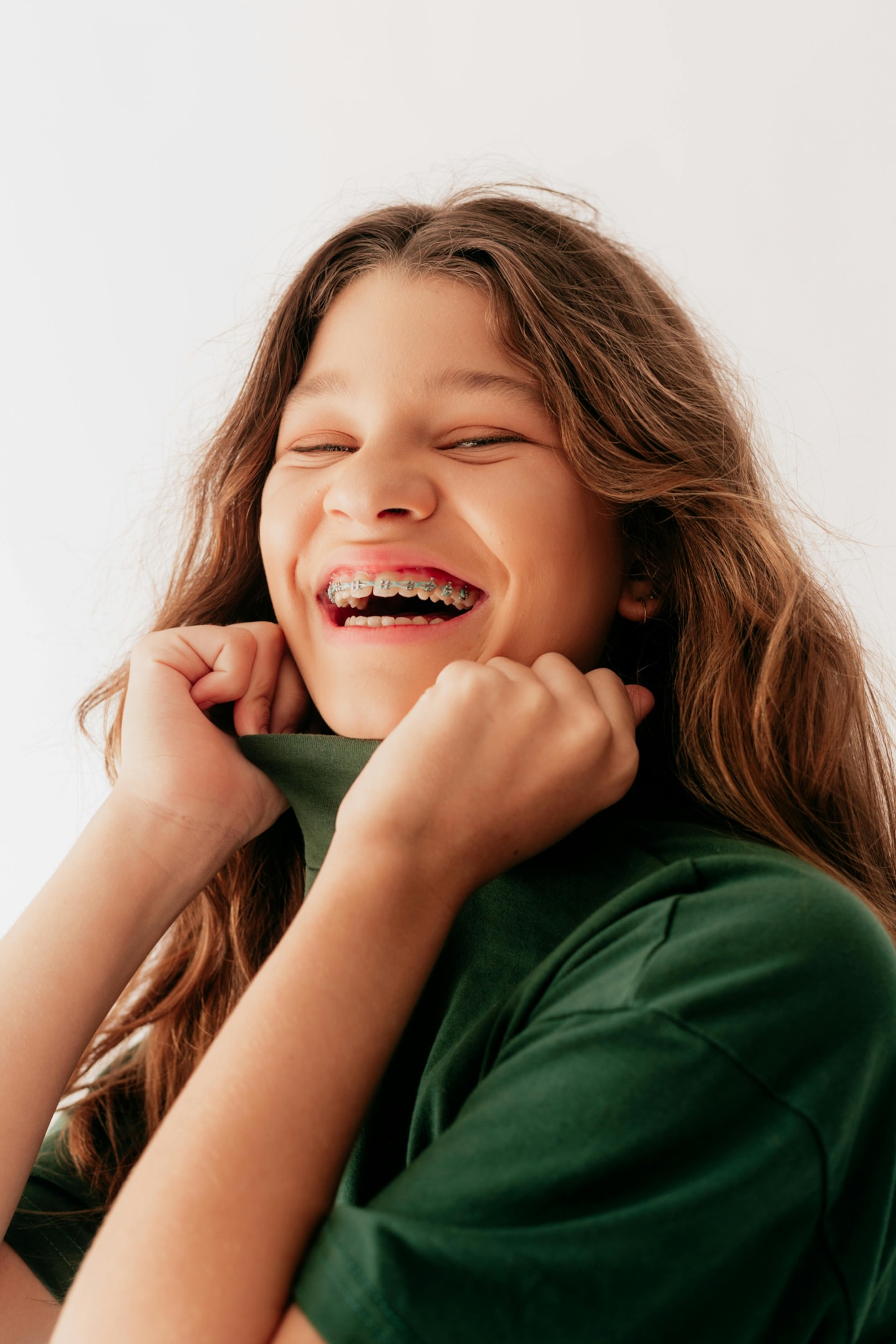 smiling teen girl in mixed dentition with braces to boost self confidence