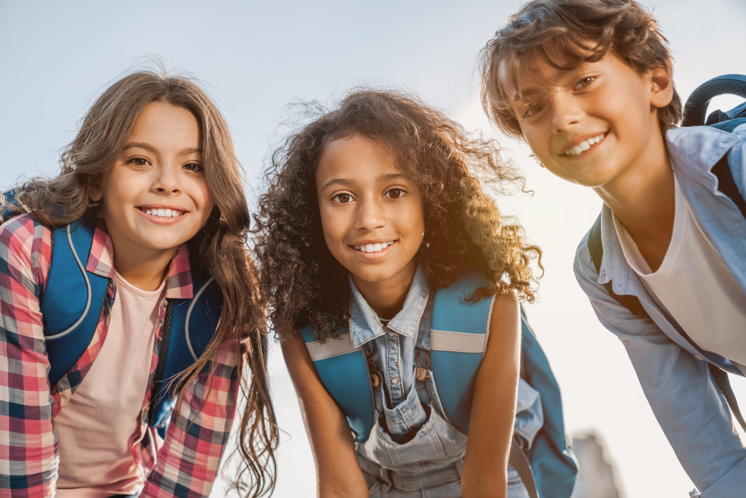 Group of kids smiling after straightening their teeth with braces