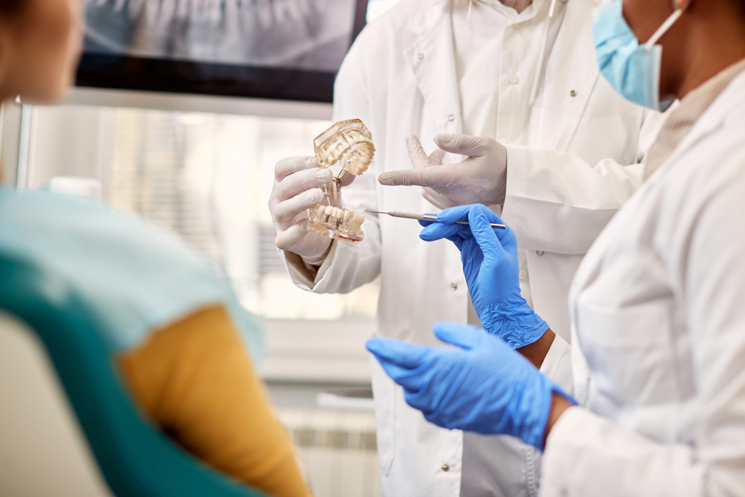 orthodontists showing a patient a dental model