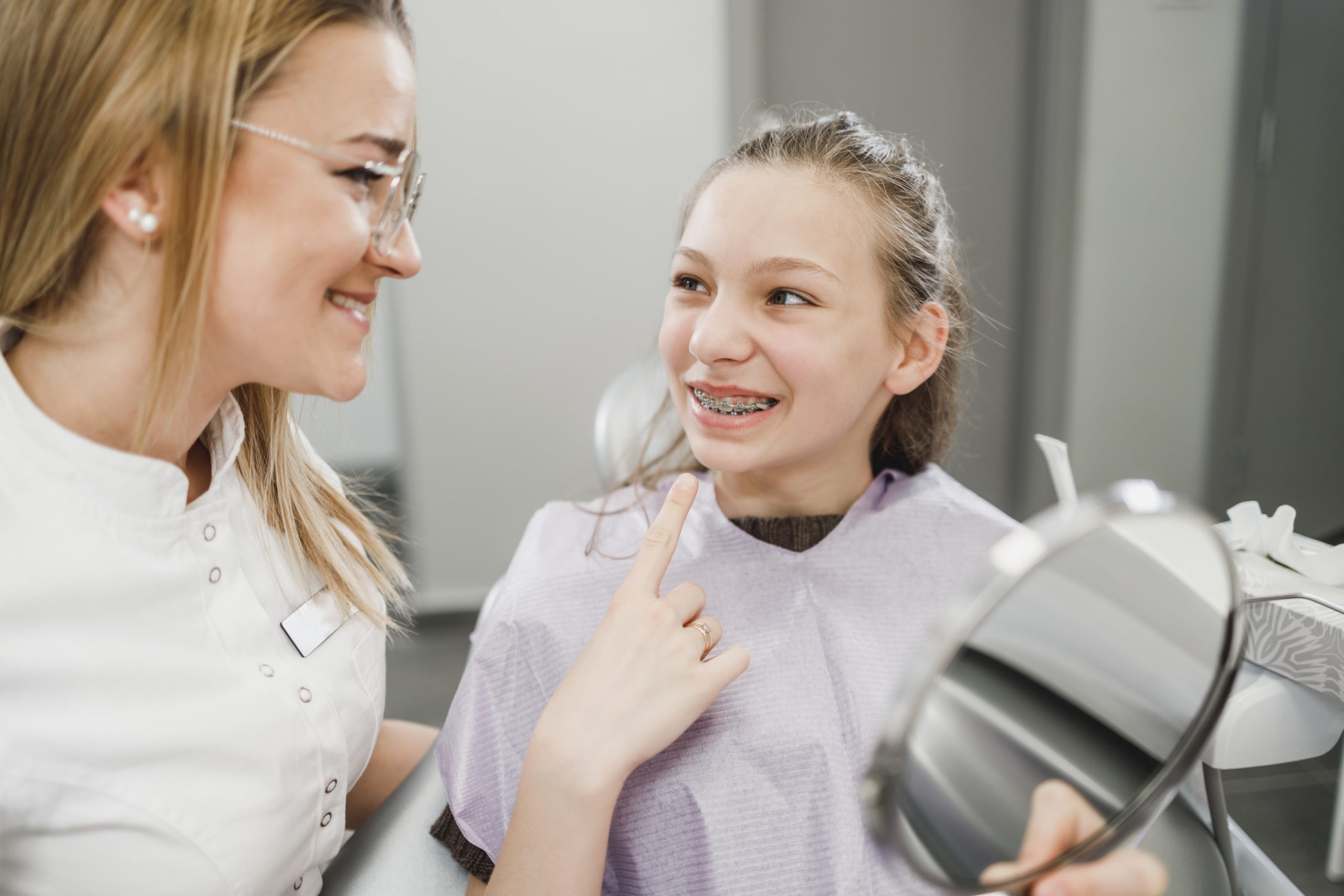 Happy young patient who just got her braces for her orthodontic treatment