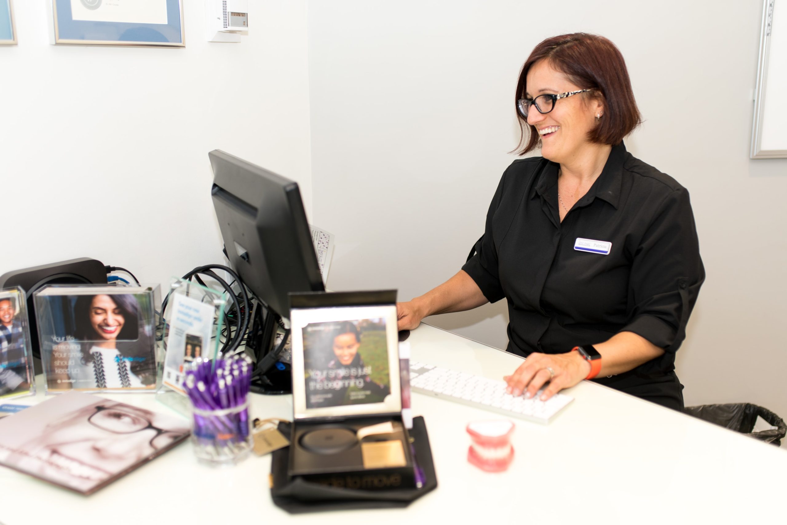 Impact Orthodontics treatment coordinator at her desk