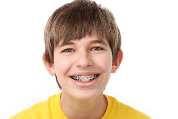 teen boy smiling with metal braces on 