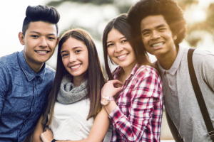 a group of teens with different orthodontic treatment plans smiling