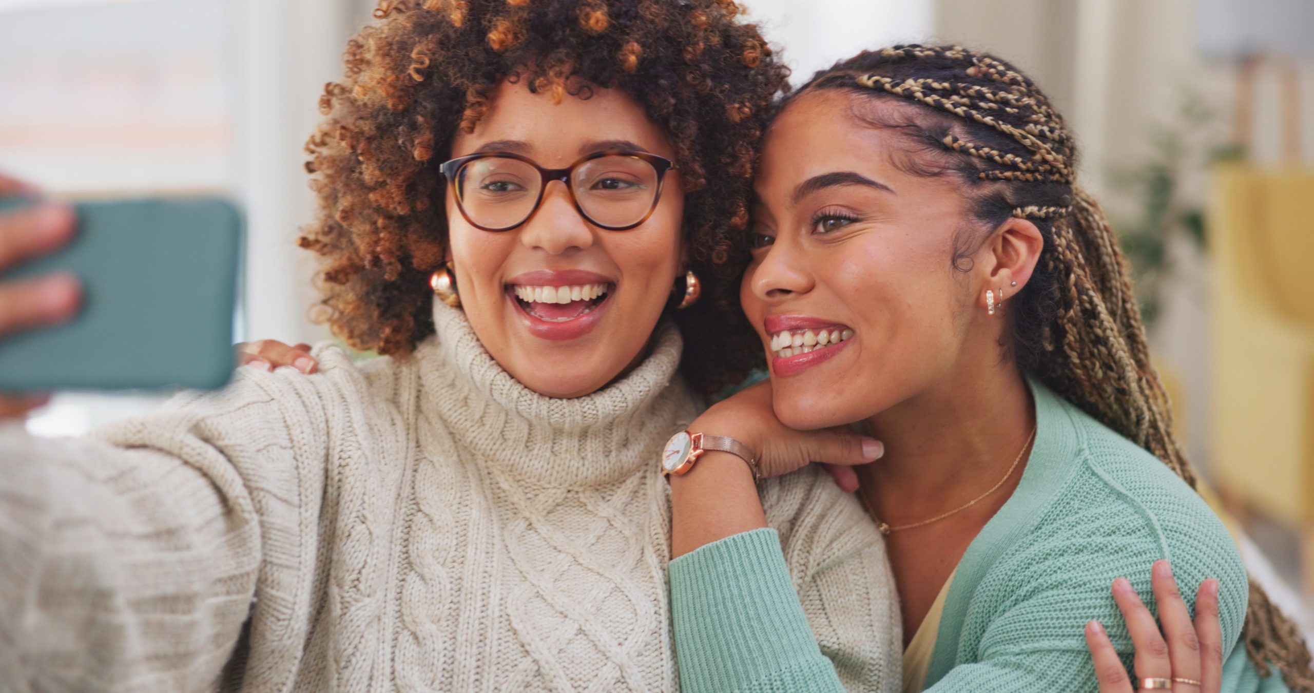 2 women smiling and taking a selfie