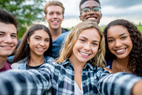 a group of teens with perfect smiles thanks to their Calgary orthodontist 