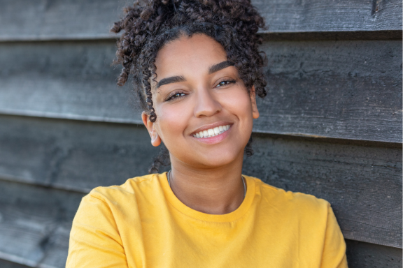 smiling teen girl who has completed orthodontic treatment with a beautiful smile