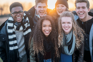 group of teens smiling knowing how does invisalign work