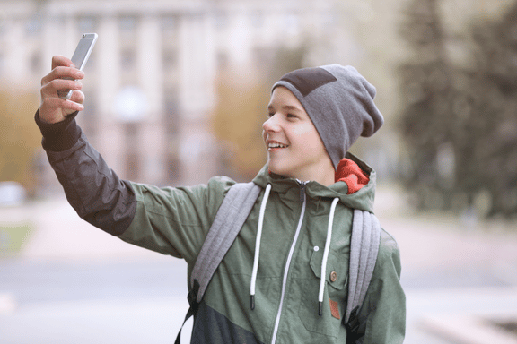 teen boy taking a selfie