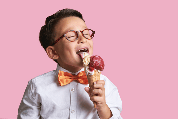 young boy licking an ice cream cone