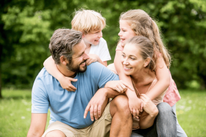 smiling mother, father and children pleased with their family orthodontic services near me