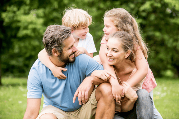 smiling mother, father and children pleased with their family orthodontic services near me