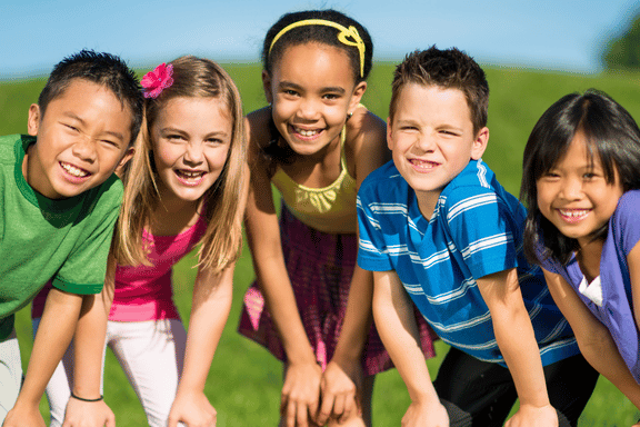 a group of young boys and girls smiling