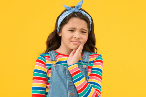 young girl experiencing jaw pain from misalignment