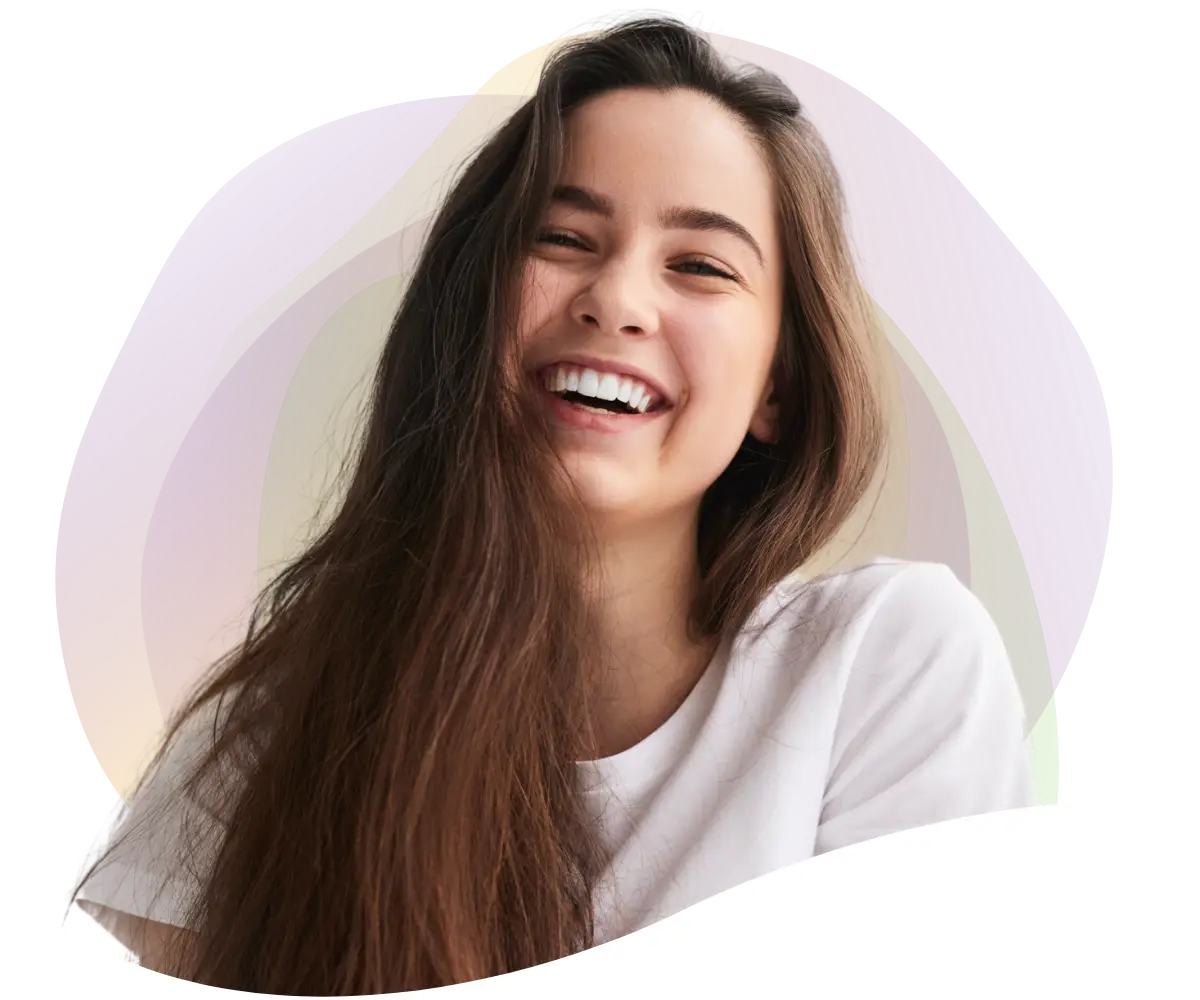 smiling teenage girl who used clear aligners during her orthodontic treatment