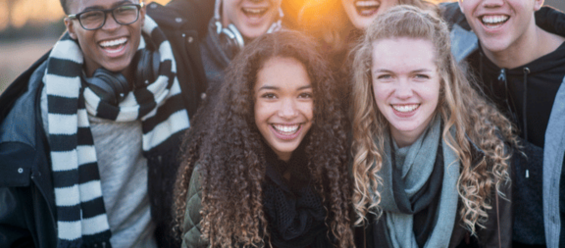 group of teens smiling knowing how does invisalign work