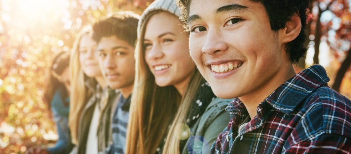 teenagers with their adult teeth smiling about meeting this Calgary orthodontist