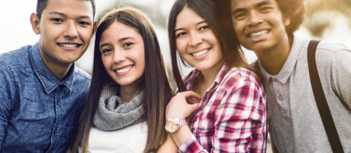 a group of teens with different orthodontic treatment plans smiling