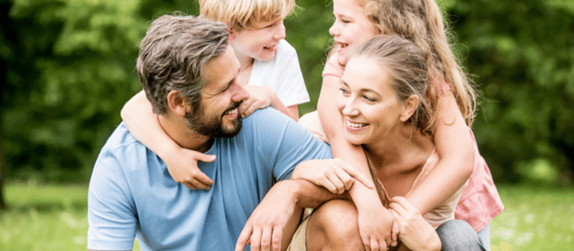 smiling mother, father and children pleased with their family orthodontic services near me