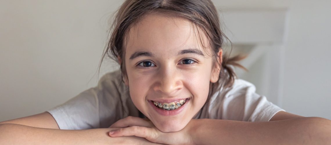 A young girl who just got her traditional braces.