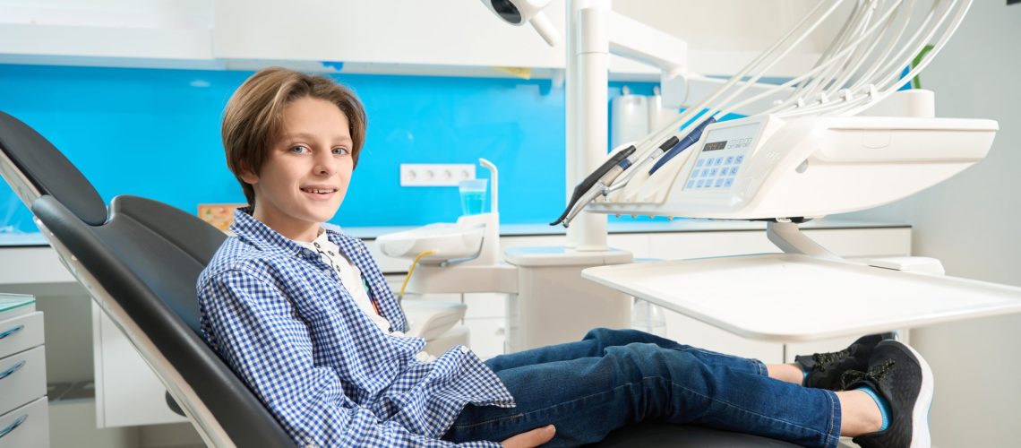 Kid sitting in patient chair for follow up care appointment