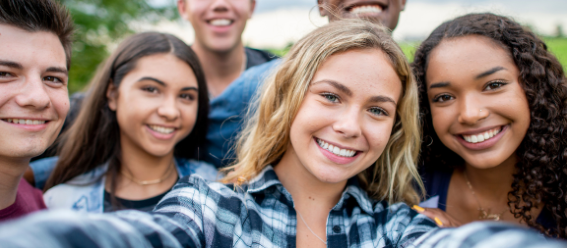 group of teens take a selfie after overbite treatment