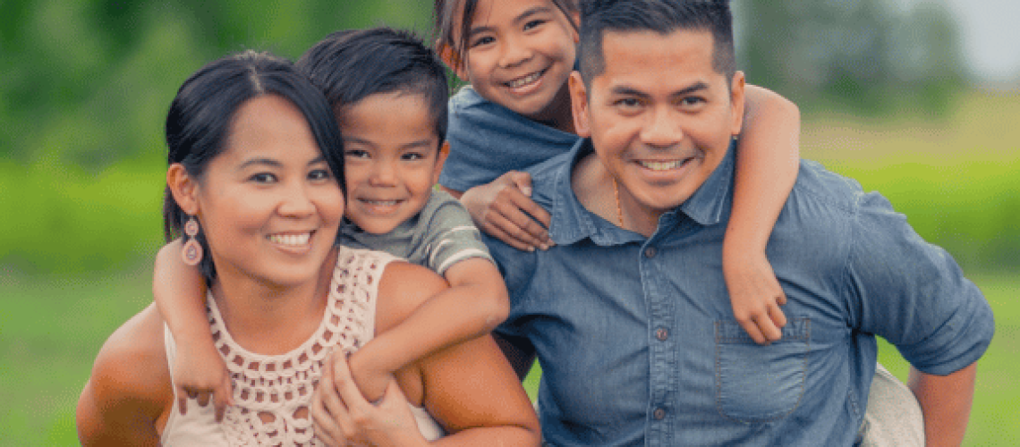 happy family with mother, father, daughter and son smiling