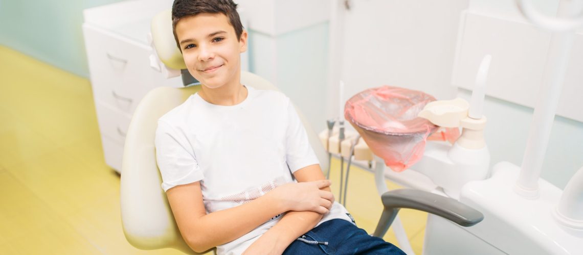 Kid sitting in patient chair for a tooth alignment consultation